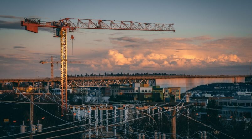 Beautiful view of a construction site in a city during sunset A beautiful view of a construction site in a city during sunset