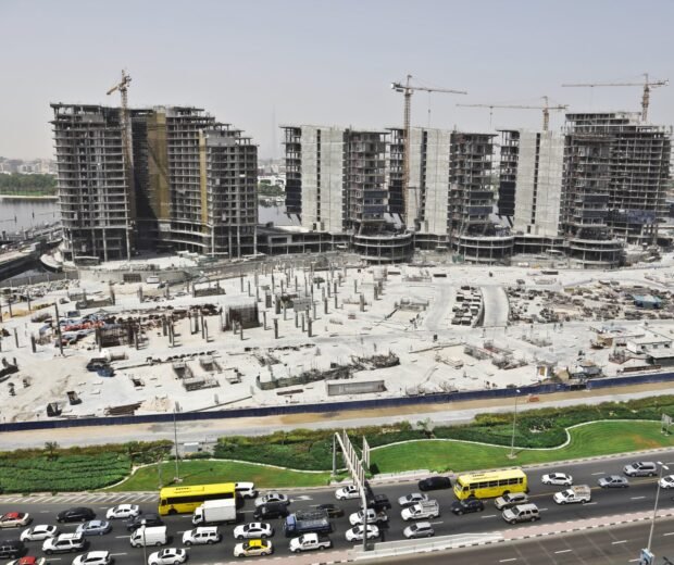 A distant shot of an urban area with cars on the street and high buildings