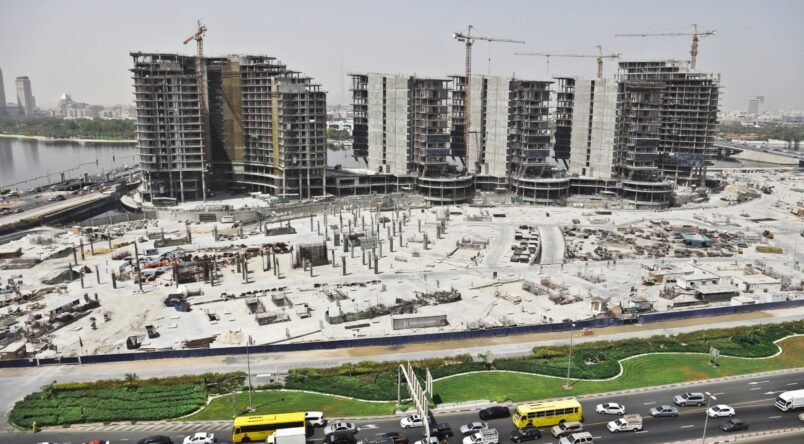 Distant shot of an urban area with cars on the street and high buildings A distant shot of an urban area with cars on the street and high buildings