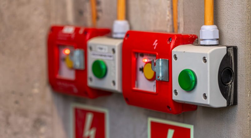 red-emergency-stop-buttons-wall-safety-devices-connected-electrical-network Close-up of a panel with two red emergency stop buttons and two green start buttons in industrial enclosures. Equipment for safety assurance on site. SSUCv3H4sIAAAAAAAAA41Py46DMAz8F59B4hHRhV+p9hASQ60CqRJnqxXKv9ehVHvdnGY88cx4B7IwQI9Vq0xblS02WNb1VJfj14RlZbtpunR9o8wEBVjNCEPdqqZWqmu7vmpUJa+AUQcyMOxAyxIDe83kNhhE8bhZ9AdES+w86UVYKiCw5hgwyJowI96zqAf/+F33PJeCEh7imEEq/jn7LkDPuJnf7J9ykQX1EXcV6f5k9OuZ7fiWK2b48GRom89Ocopb33hznHePBHbmTvZcfp9xI5n6nAXxsTht0Z5yHFdi/lCPP4TPv98ppRdqBJK9hAEAAA==